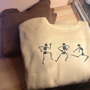 2 crewnecks with skeletons each size S in women’s, both run to be oversized.